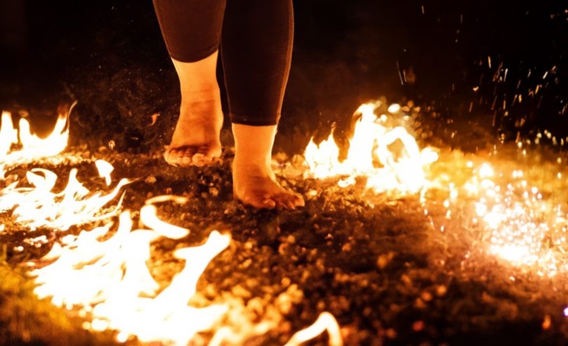 Close up of a lady walking on hot coals for a firewalk