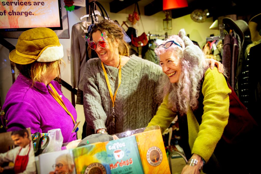 A charity shop retail team of volunteers at the checkout